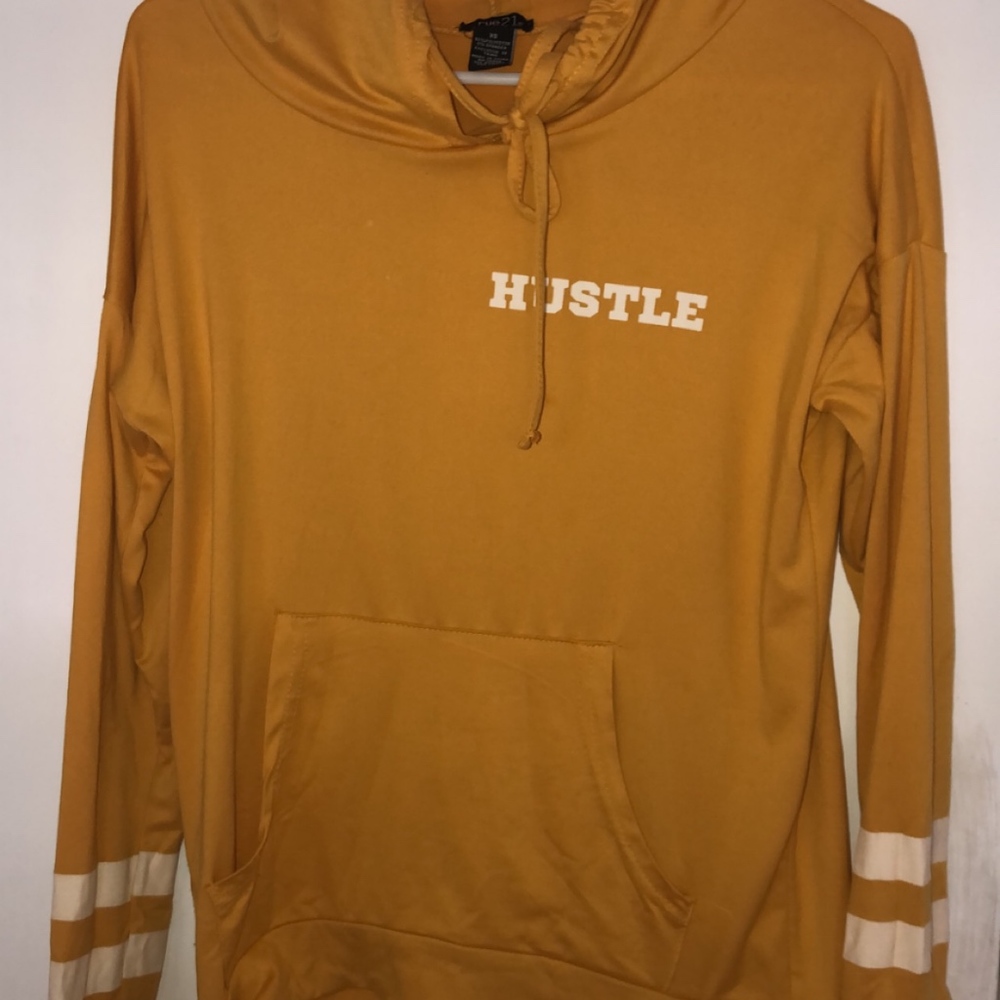 yellow ' hustle ' sweatshirt .